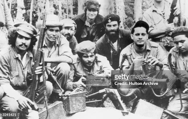 Group photo of Cuban citizen militia displaying weapons captured from dictator Fulgencio Batista's army in Fidel Castro's '26 of July Movement,'...
