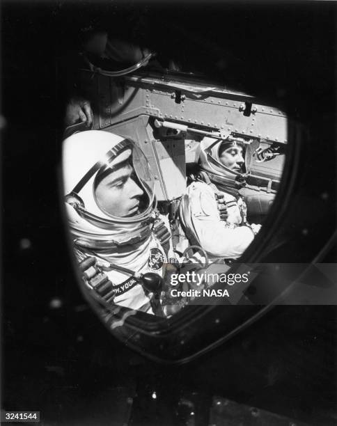 American astronauts John W. Young and Virgil 'Gus' Grissom sitting in the GT-3 spacecraft just before the hatches were closed, in the Gemini flight...