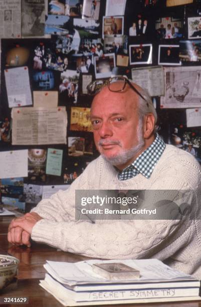 Portrait of American theater producer and director Harold Prince seated at a desk with his hands crossed. Prince has worked on over 50 musicals and...