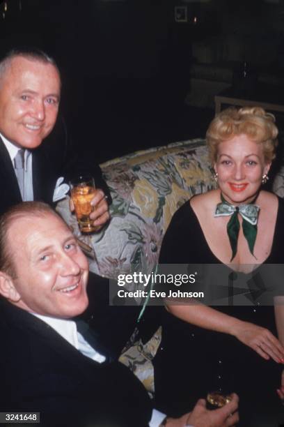 Director, Henry Hathaway , and actors, Frederick Brisson and Ann Sothern smile during a St. Patrick's Day party in the home of actor Van Johnson and...