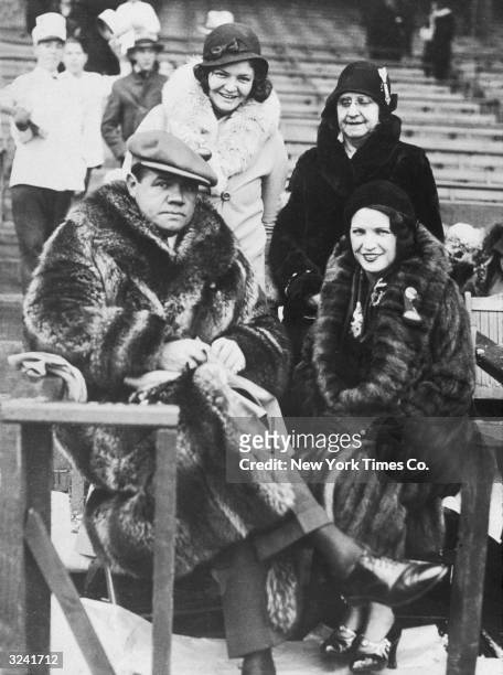 American baseball player Babe Ruth sits in the stands at a stands at a stadium with his wife, Claire Hodgson Ruth , sister, and mother-in-law, New...