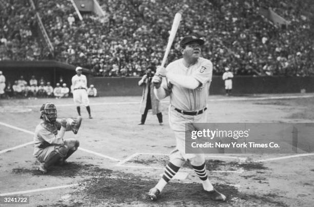 American baseball player Babe Ruth hits his first home run during his tour of Japan at Miji Shrine Stadium, Tokyo, Japan.