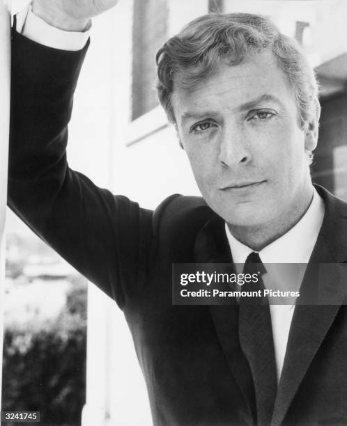 Portrait of British actor Michael Caine leaning on one arm in a still from director Lewis Gilbert's film, 'Alfie'.