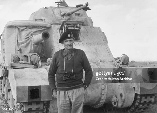 British Field Marshal Sir Bernard L. Montgomery stands in front of a General Grant tank in civilian clothing.