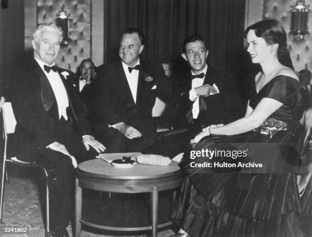 From left to right, British actor and director Charles Chaplin , American newspaper columnist Harry Crocker, and American songwriter Adolf Green, all...