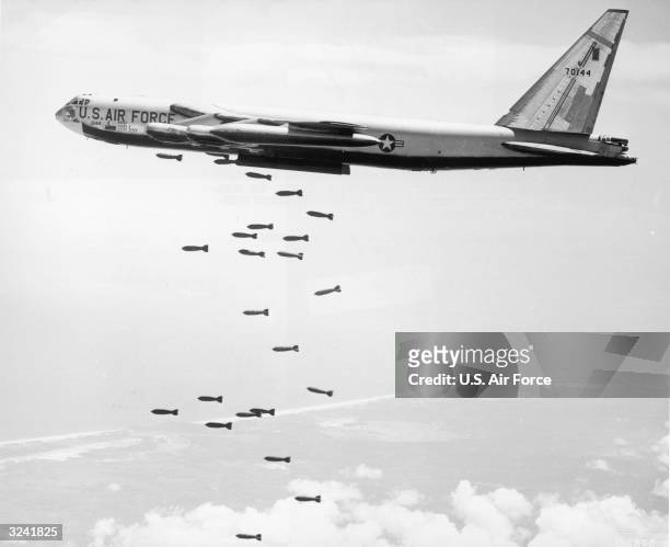 Air Force strategic air command B-52 stratofortress drops a string of 750-pound bombs over a coastal target in the Republic of Vietnam during the...