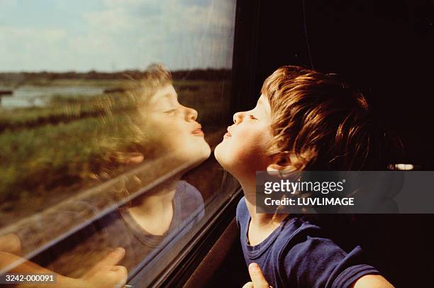 child and reflection in window - vagone foto e immagini stock