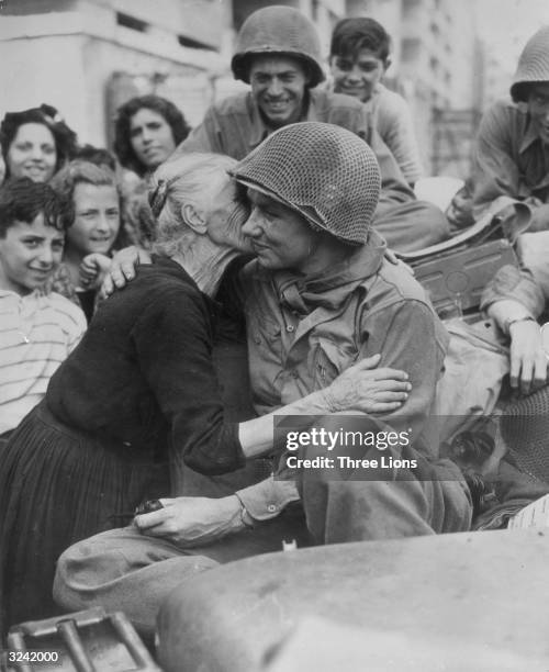 An old Italian woman shows her gratitude to one of the American soldiers following the liberation of Italy.