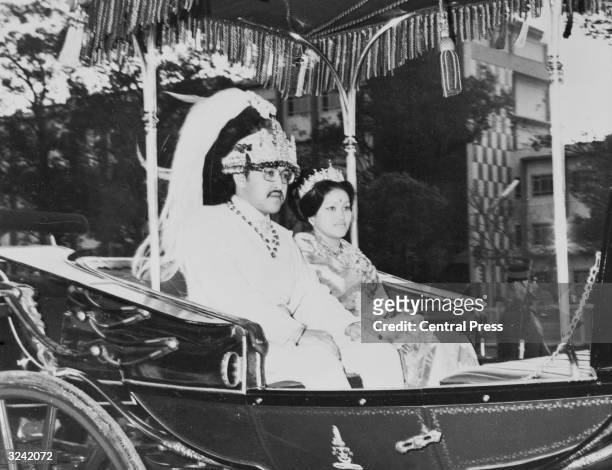King Birendra and Queen Aishwarya of Nepal ride their ceremonial carriage following their coronation ceremony in Katmandu.