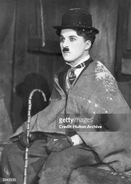 British comic actor and director Charlie Chaplin , as the Little Tramp, wearing a burlap shawl in a still from 'The Gold Rush' directed by Chaplin.