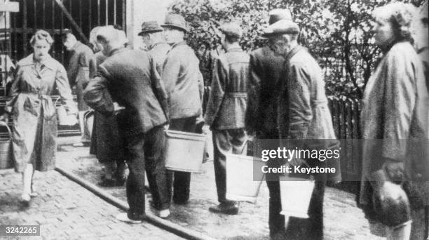 Picture published in the Nazi Party's weekly magazine, the 'Illustrierte Beobachter', showing civilians in Berlin queuing for water from a standpipe...