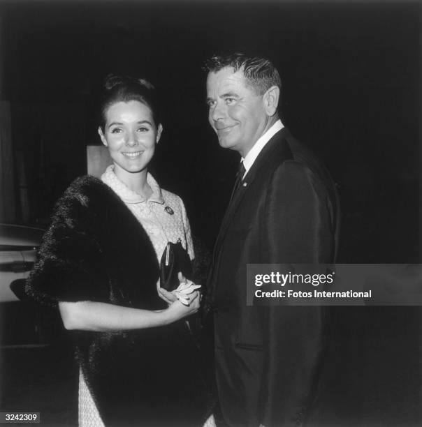 American actor Glenn Ford and his wife, American actor Kathryn Hays, standing at a benefit for Pasadena Playhouse, California. Hays is wearing a dark...