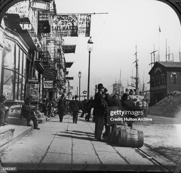 People walk along South Street, near the docks, in New York City..