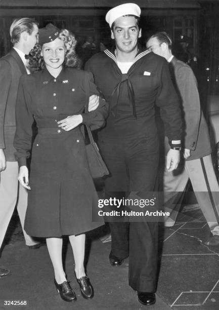 American actor Rita Hayworth with her date, American actor Victor Mature , arriving at the West Coast premiere of director Sam Wood's film, 'The...