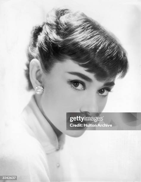 Belgian-born actor Audrey Hepburn wearing earrings.