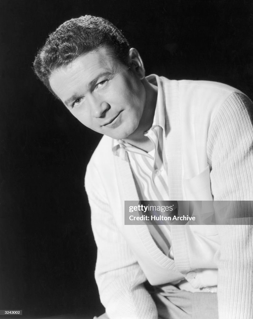 Portrait of American comedian and actor Red Buttons wearing a white ...