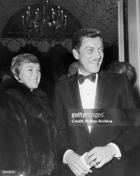 American actor Dick Van Dyke and his wife, Marjorie Willet, at a formal event. Van Dyke is dressed in a tuxedo, and Willet is wearing a fur coat.