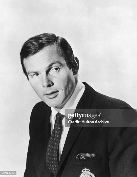 Promotional studio portrait of American actor Adam West looking to one side, dressed in character as Bruce Wayne from the television series, 'Batman'.