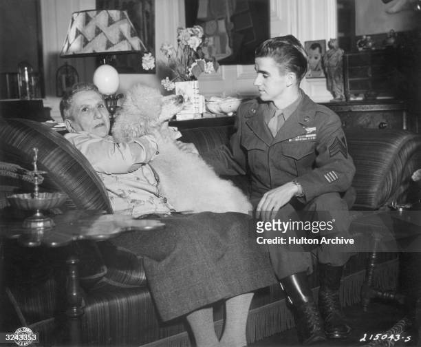 American author Gertrude Stein and Sergeant Robert Ashley in Stein's Paris apartment preparing to be filmed for a movie sponsored by the Information...