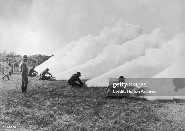 Students releasing smoke from chemical cylinders at the Army Chemical Warfare Service School at Edgewood Arsenal, Maryland, World War I. The school...