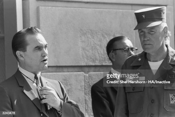 Segregationist Alabama Governor George C. Wallace blocks the doorway to the University of Alabama while talking to Brigadier General Henry Graham of...