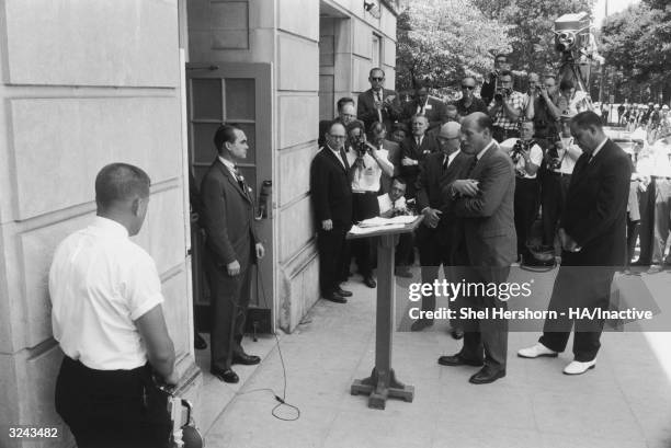 Segregationist Alabama Governor George C Wallace blocks the doorway to the University of Alabama while listening to Nicholas Katzenbach, US Deputy...