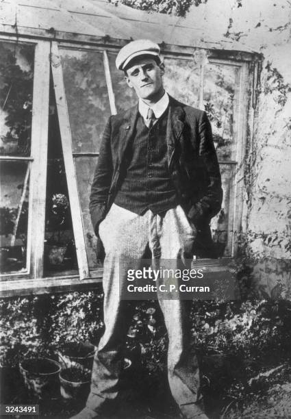 Portrait of Irish writer James Joyce, aged 22, standing outdoors.