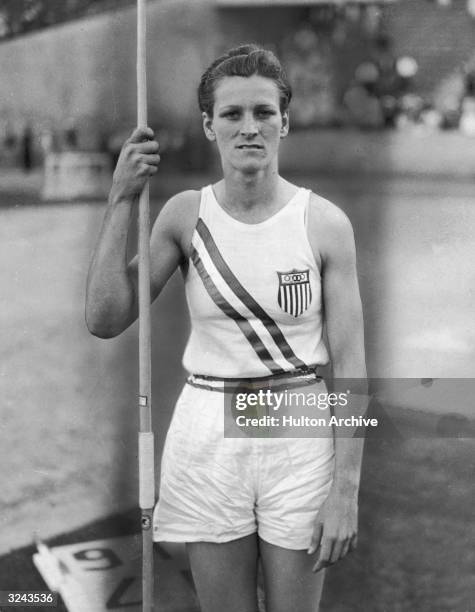 Portrait of American athlete Babe Didrikson Zaharias holding a javelin and wearing her Olympic uniform, Los Angeles, California. Babe saet a new...