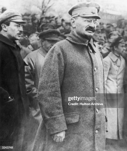 Revolutionary leader and author Leon Trotsky walks in a crowd of people outdoors during the Russian Revolution, Soviet Union.