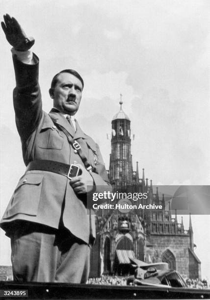 German dictator Adolf Hitler giving the Nazi salute from his car whilst at the Nazi Party Congress.