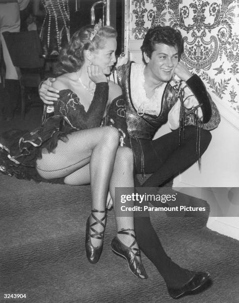 American actors Janet Leigh and Tony Curtis sit together on a carpeted staircase, in costume as William Shakespeare's Romeo and Juliet. They were...