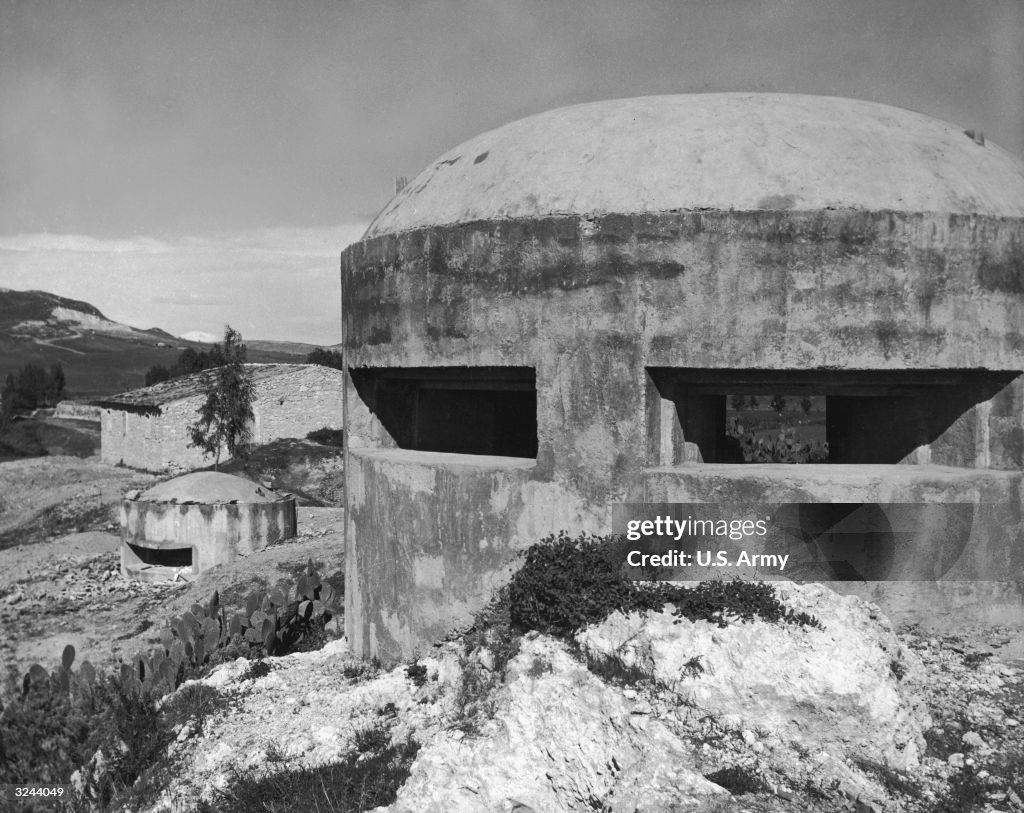 View Of Two Round Concrete Bunkers Called pillboxes Used By German view-of-two-round-concrete-bunkers-called-pillboxes-used-by-german