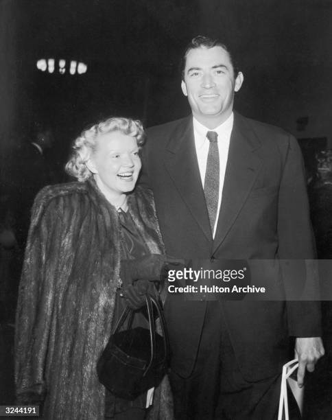 American actor Gregory Peck and his wife, Greta Rice, laugh as they arrive at a Friars Club event.