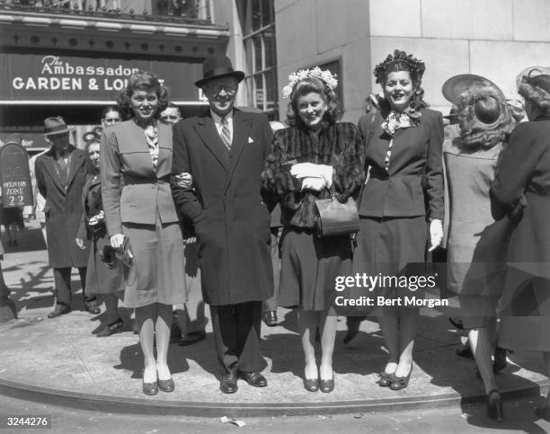 American businessman and ambassador Joseph P. Kennedy Sr. Links arms with his daughters Eunice Kennedy, Rosemary Kennedy , and Patricia Kennedy as...