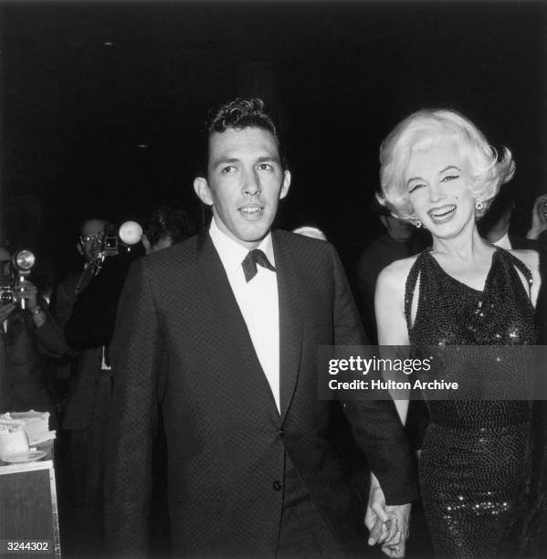 American actor Marilyn Monroe holds hands with her date, writer Jose Bolanos , at the Hollywood Foreign Press Association awards , California....