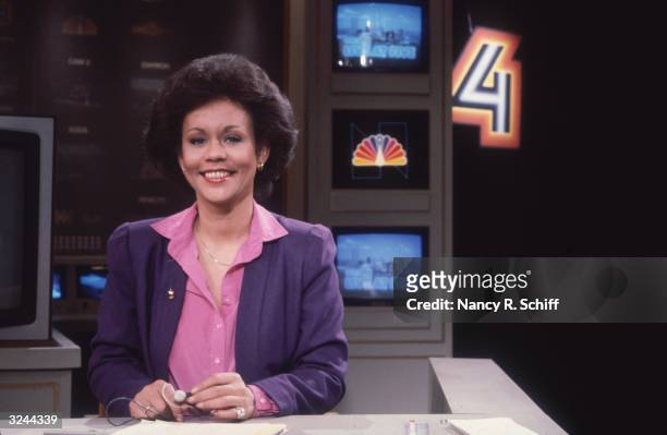Portrait of American television newscaster Sue Simmons sitting behind a desk on the set of the NBC Channel 4 Evening News.