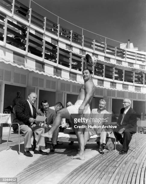American boxer Rocky Marciano , heavyweight champion, wears a bathing suit while talking to the press after announcing he would join Jimmy Durante in...