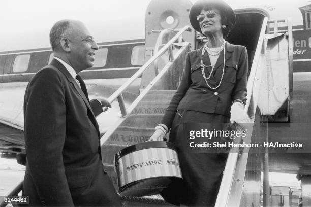 French fashion designer Coco Chanel says goodbye to American department store executive Stanley Marcus as she boards an airplane in Dallas, Texas....