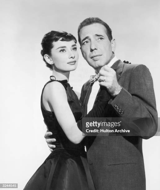 American actor Humphrey Bogart and Belgian-born actor Audrey Hepburn (1929 - 1993 dance together in a promotional portrait from director Billy...