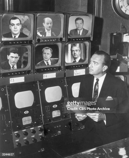 American broadcast journalist Walter Cronkite stands before a group of television monitors showing the CBS News Correspondents who were the on-scene...