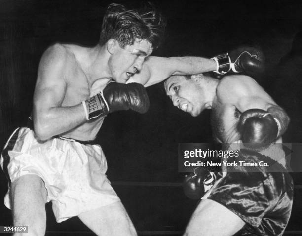 American boxer Jake La Motta weaves under under a punch thrown by Tommy Yarosz in the third round of their bout at Madison Square Garden, New York...