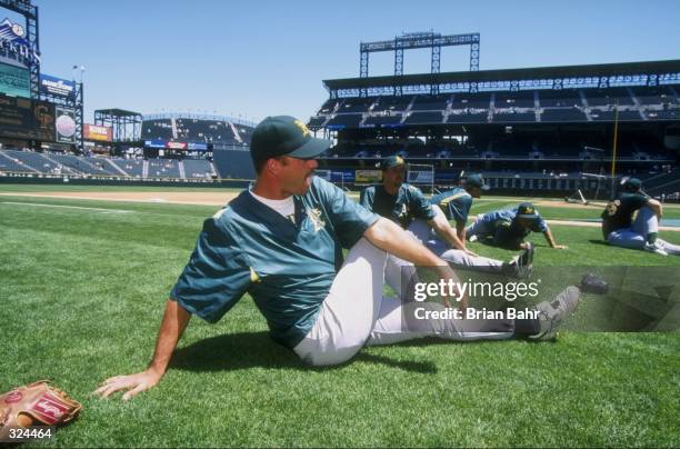 Member of the Oakland Athletics participates in a pre- game stretch during an interleague game against the Colorado Rockies at Coors Field in Denver,...