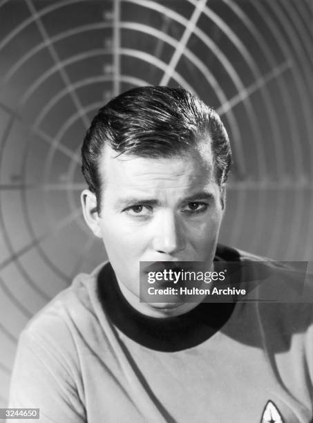 Canadian-born actor William Shatner wears a starship uniform as Captain James T Kirk in a promotional portrait for the science fiction television...