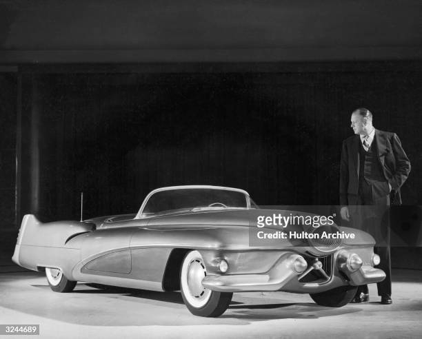 Harley J Earl, vice president in charge of styling at General Motors, looks over the full scale model of the 1951 Buick Le Sabre sports car. The...