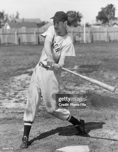 Full-length portrait of American baseball player Ted Williams , aka 'The Splendid Splinter,' ourfielder and slugger for the Boston Red Sox, taking a...