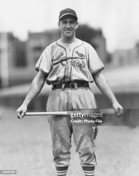 American baseball player Enos Slaughter , outfielder and slugger for the St. Louis Cardinals, wearing his uniform while holding a baseball bat.