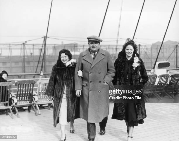 American baseball player George Herman 'Babe' Ruth walks with his wife, Claire Merritt Hodgson , and sister, Julia, on the deck of a ship.