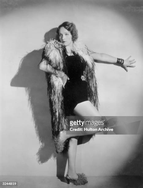 German-born actor Marlene Dietrich poses in a cabaret costume and ostrich feather boa in a promotional portrait for director Josef von Sternberg's...