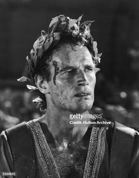 American actor Charlton Heston wears a laurel wreath on his head in a still from director William Wyler's film, 'Ben-Hur'.