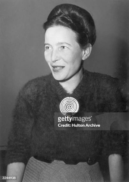 Portrait of French author and early feminist Simone de Beauvoir , wearing a brooch designed by artist Alexander Calder.